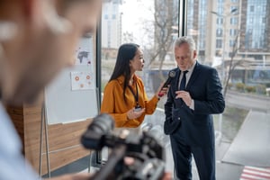 Man being interviewed by news reporter