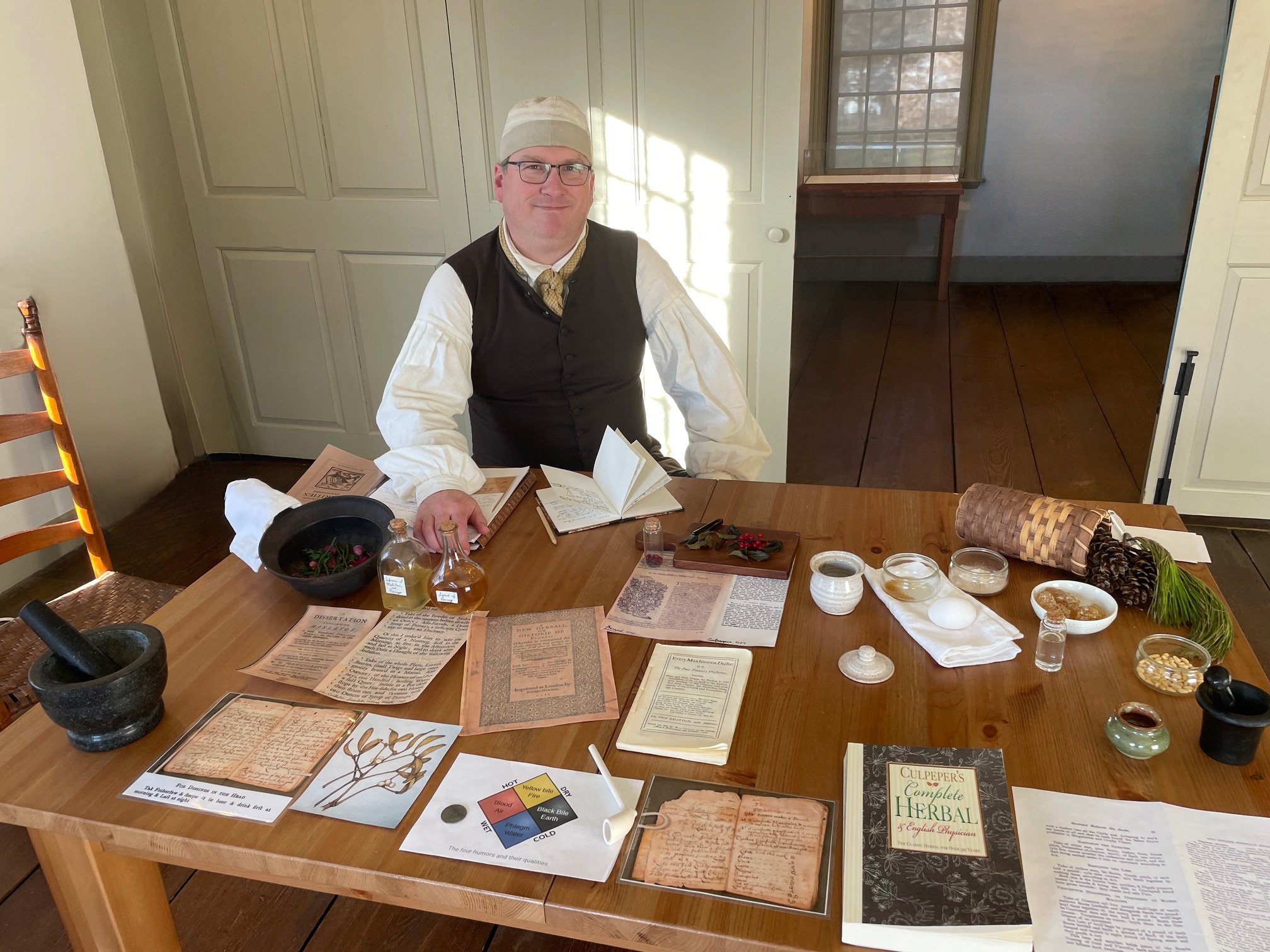 A man dressed in historical garb in Buckman Tavern.