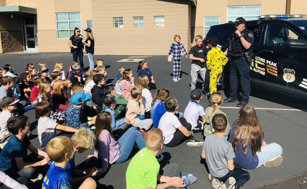 A group of children outside of the Lone Peak Police Department.