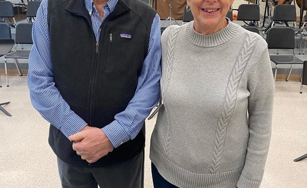 Bob and Barbara Pacheco, the parents of late Bourne High School teacher Robert A. Pacheco Jr., stand in front of the digital piano they donated to the high school's music department. (Photo courtesy Bourne Public Schools)