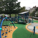 Newly remodeled Cypress Playground, with green and yellow surface and new play equipment.