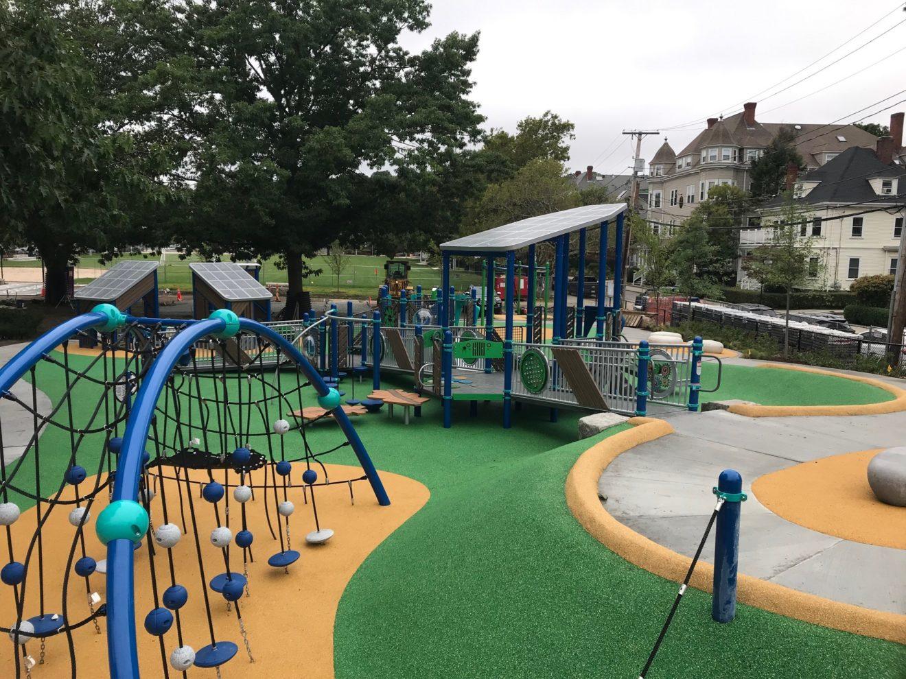 Newly remodeled Cypress Playground, with green and yellow surface and new play equipment.