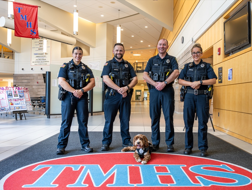 Four Tewksbury Police School Resource Officers standing in the hallways of TMHS.
