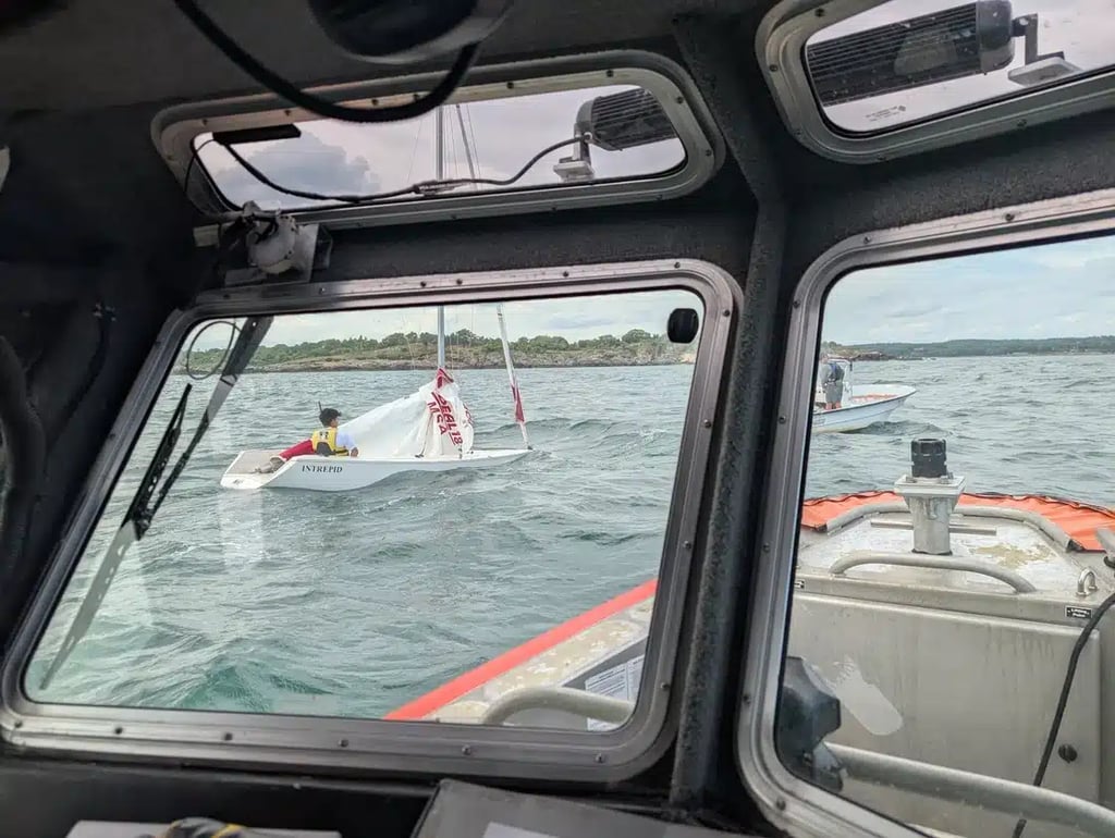 Sailboat being towed to shore