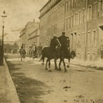 Ladderman John L. Glynn (rear) and another ladderman exercising Ladder 12's horses on Cabot St., Roxbury, circa 1908.