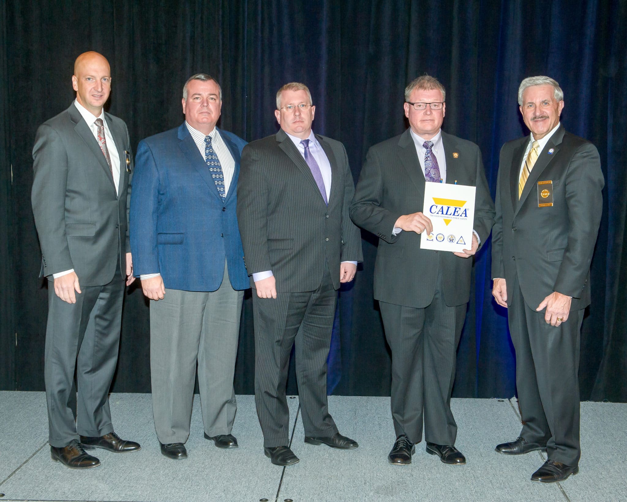 Danvers Police Captain/Accreditation Manager Patrick Ambrose (left), Lieutenant James Lovell (middle), and Chief Neil Ouellette (second from right) receive the CALEA Re-Accreditation Award from CALEA officials. Pictured are Executive Director W. Craig Hartley Jr. (Second from left) and Commission Chairman J. Grayson Robinson (right). (Courtesy of the Danvers Police Department)