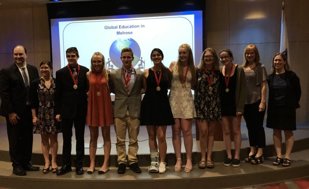 Teachers Michael Noone and Suzanne Troy alongside award-winning students James Talbot, Holly Moore, Lucien Carbonneau, Isabel Castro, Emma Bates, Helen Burtnett, Lauren Reilly, and fellow teachers Michelle Stepper and Denise Wagstaff at the Global Education in Melrose Celebration. (Courtesy Photo Melrose Public Schools)