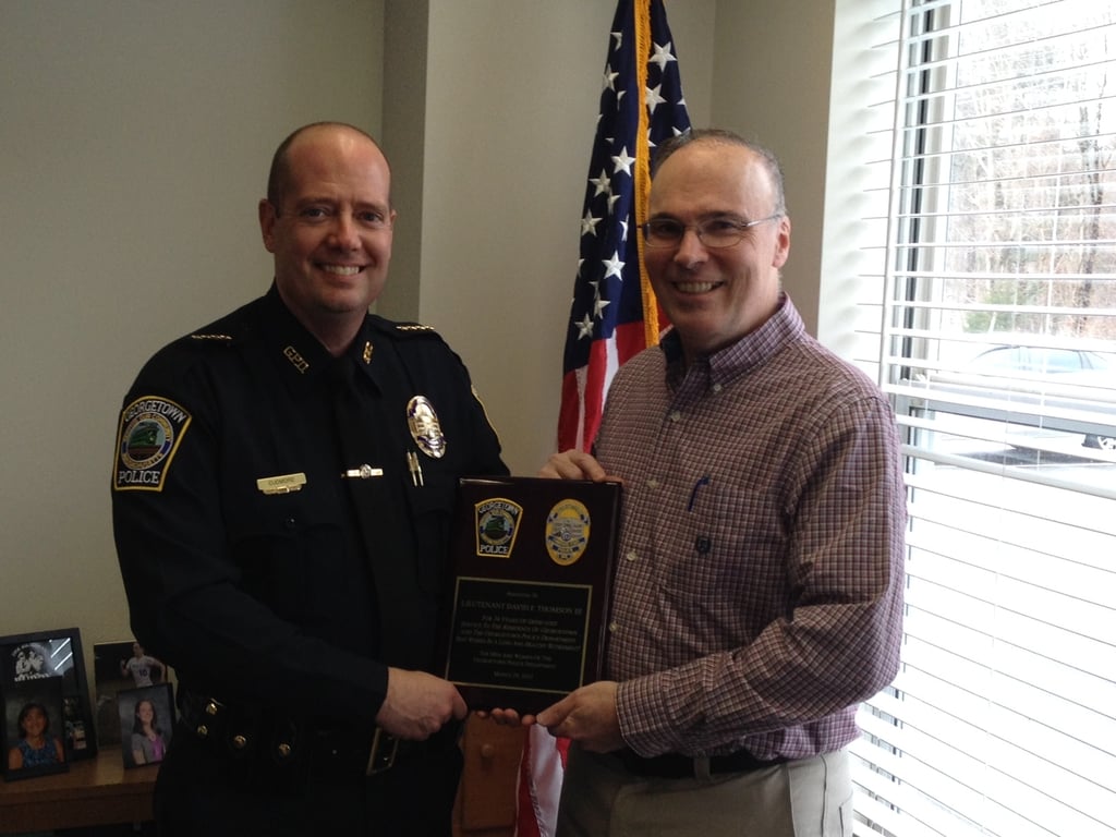 Chief Cudmore (left) congratulates retiring Lieutenant David F. Thomson III. (Georgetown Police Courtesy Photo)