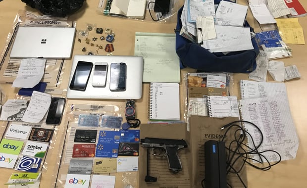 Officers conducting an on-scene investigation during a traffic stop located a silver and black BB gun, dozens of credit cards, a credit card reader and fraudulent driver's licenses in a vehicle. A 27-year-old Woburn man was arrested.