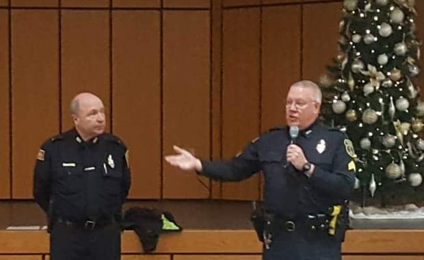 Lt. James Graham (left) and Sgt. Paul Saunders discuss common types of computer, phone and mail scams with residents of Carleton-Williard Village on Dec. 18, 2018. (Courtesy Photo/Bedford Police Department)
