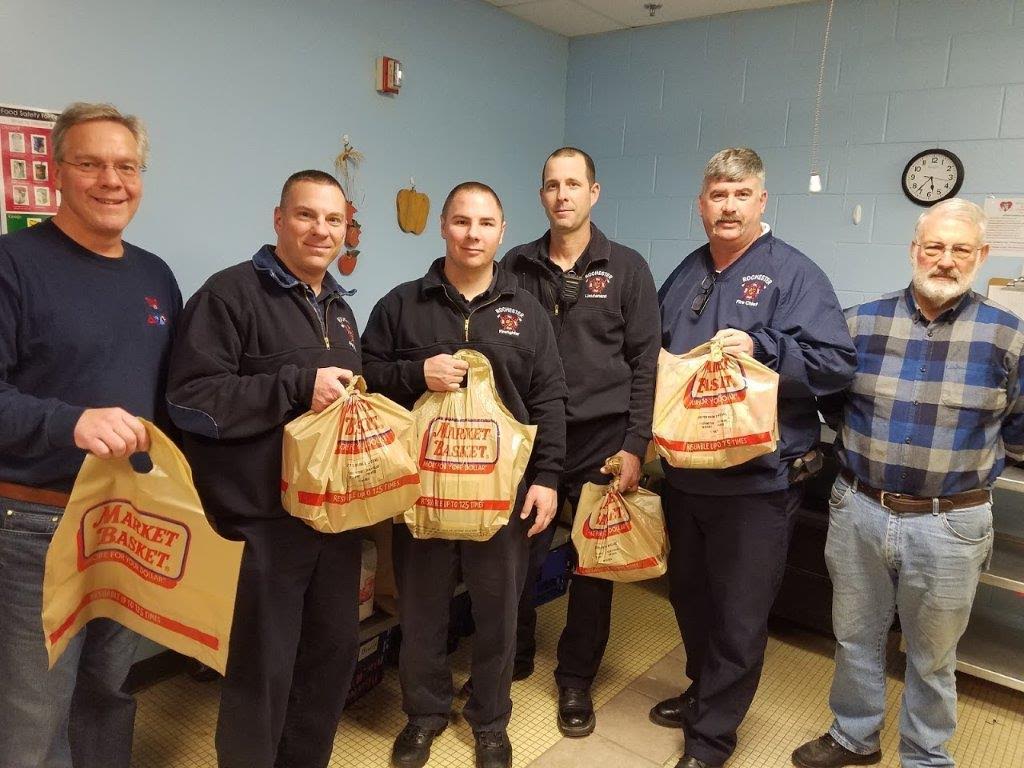 Members of the Rochester Fire Department pose with bags of food that will go to city children to help ensure that they have healthy meals to eat during the weekend days when they are away from school. Pictured left-to-right: Dave Bogan, Jason Laferte, Matthew Parker, Mike George, Chief Mark Klose, Former Mayor John Larochelle (Courtesy photo)