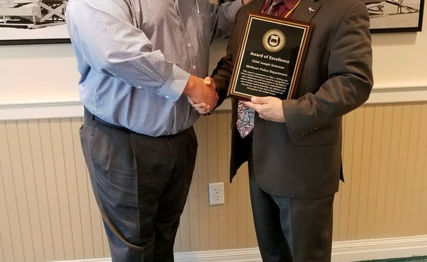 Curtis Lavarello, Director of the School Safety Advocacy Council (left) presents Methuen Police Chief Joseph Solomon with an award recognizing the Methuen Police Department's work in sharing its expertise on the topic of school safety and security. (Courtesy Photo)