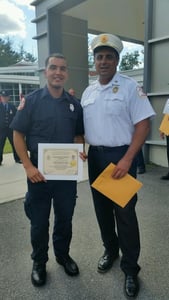 Firefighter/paramedic Chris Gonzalez, left, completed the Massachusetts Firefighting Academy this afternoon and will join Chief David Grunes, right, as a member of the Bedford Fire Department. (Courtesy Photo)