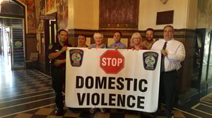 Gloucester officials appointed their first Domestic Violence Police Officer today. Left to right, Officer George Carr, Mayor Sefatia Romeo Theken, Sunny Robinson, Co-Chair of the Gloucester Coalition for the Prevention of Domestic Abuse, Officer Ronald Piscitello, Nicole Richon-Schoel, Co-Chair of the Gloucester Coalition for the Prevention of Domestic Abuse, Ross Steinborn, Education and Outreach Specialist from the North Shore Rape Crisis Center, and Police Chief Leonard Campanello.