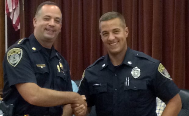 Chief Warren B. Ryder (left) shakes hands with new full-time Boxborough Police Officer Robert Fagundes