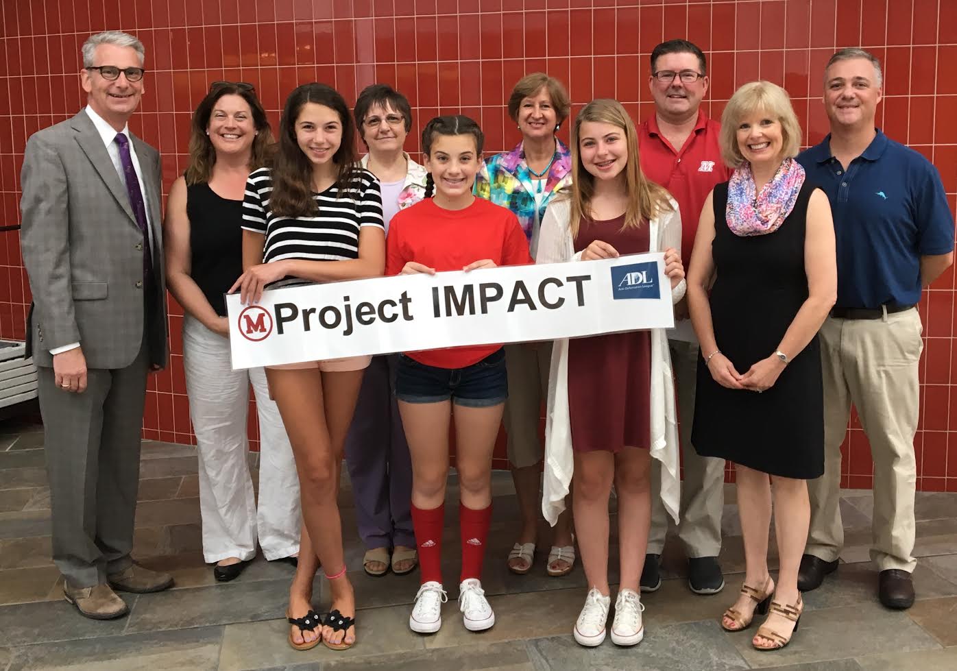 Students and community leaders gather for the kickoff event of Project IMPACT on July 14. Rear row left to right: Jim Oosterman, Melrose Cooperative Bank Foundation, Kim LaFontana, Melrose Education Foundation, Diane Indorato, Melrose Cooperative Bank Foundation, Beth McNelis, Melrose Rotary Club, Jamie Parsons, MVMMS Assistant Principal, Brent Conway, MVMMS Principal Front row left to right: MVMMS students Grace Wagner, Michela Galego, Mia Swift and Rebecca Mooney, Executive Director of the Melrose Alliance Against Violence. (Courtesy Photo)