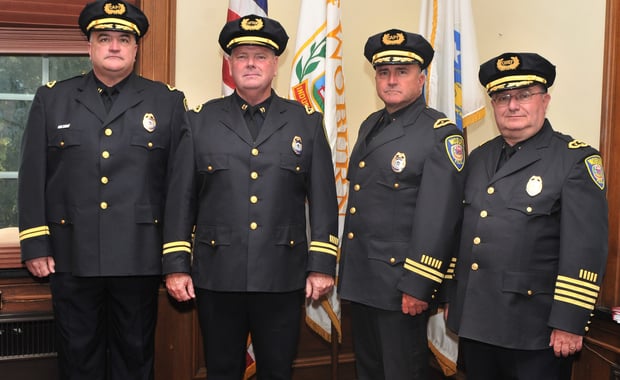 Woburn PoliceDepartment's newest Captain, Captain John O'Neil (2nd from left) was sworn in recently, here he is with (l-r) Capt John Murphy, O'Neil, Capt Robert Rufo and Chief Robert Ferullo. (Photo by JoeBrownPhotos.com for the Woburn Police Department)