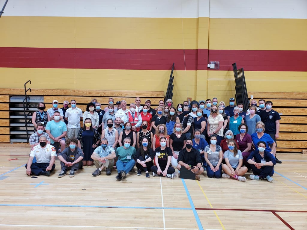 Fully-vaccinated leaders, organizers and volunteers pose for their first group photo in more than a year at the end of the Lower Merrimack Valley Regional Collaborative's final weekend COVID-19 on Saturday, May 22, 2021. Nearly 30,000 doses of the vaccines were administered by the dedicated group. (Photo courtesy Lower Merrimack Valley Regional Collaborative)