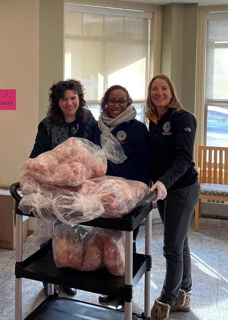 Julie Washburn, Darlene Johnson and Sara Schaffer roll the turkeys on a cart ready to go to Brookline families in need. (Courtesy photo)
