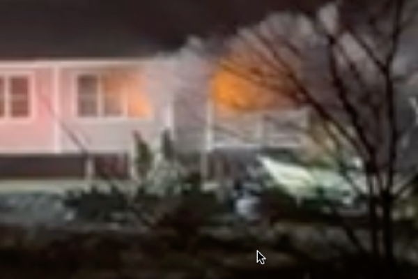 Firefighters pour water on house fire