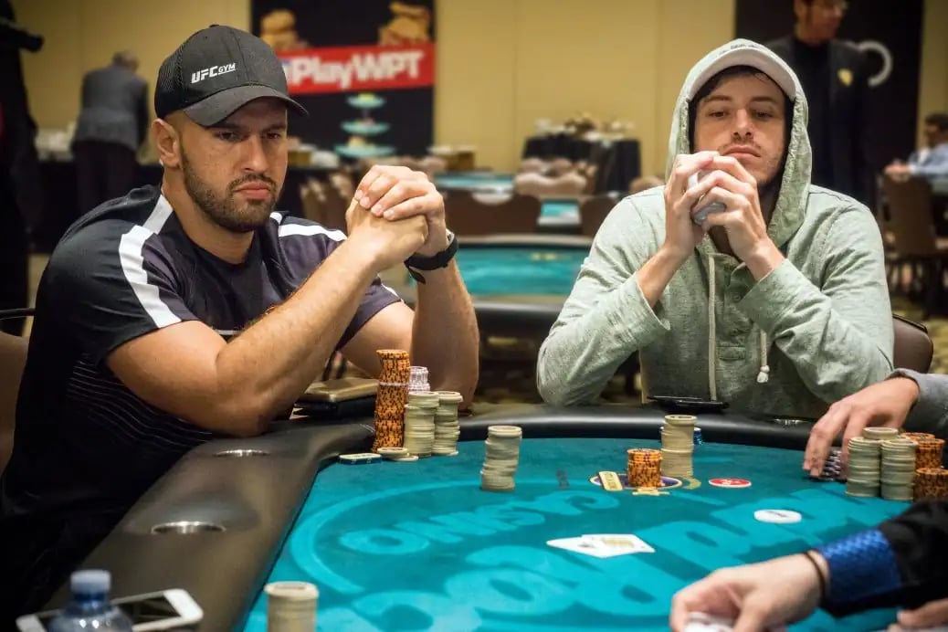 Michael Mizrachi and Daniel Weinman sit at a WPT tournament table with sizable chip stacks in front.