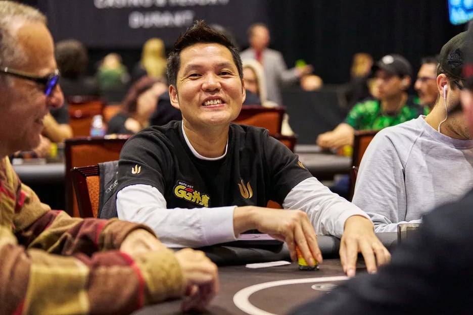 Ren Lin playing at a live poker event, focused at the table during a major tournament.