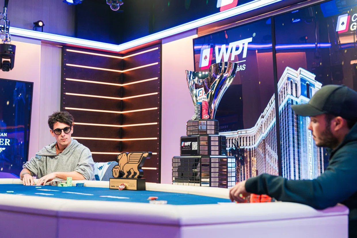 Nico Betbese and Francis Cruz competing at the Venetian Las Vegas final table, with the Mike Sexton Champions Cup trophy displayed.