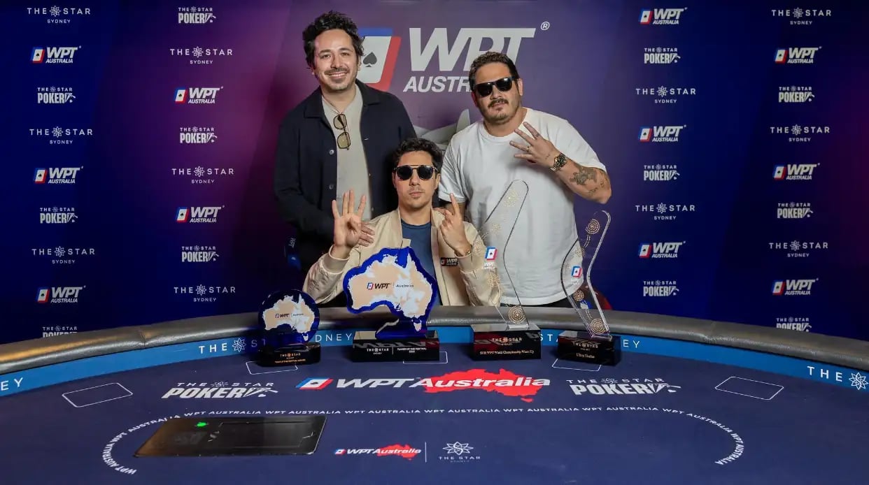 Sergio Barros poses with two friends and four WPT® Australia trophies after his breakout run.