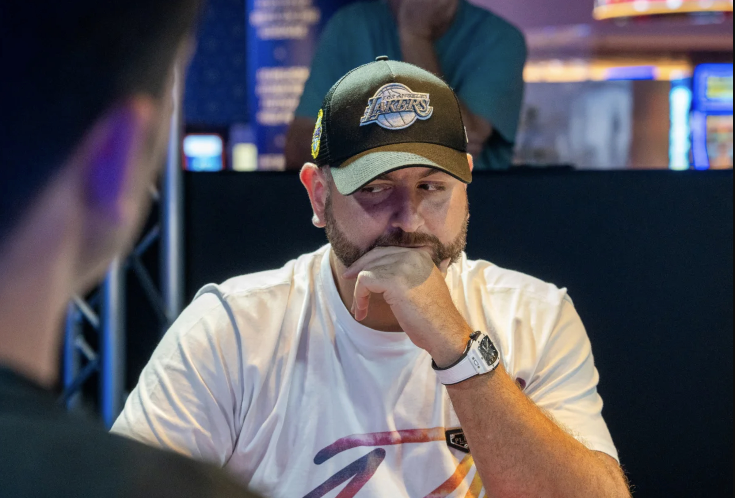 Patrick Yazbeck deep in thought during a WPT event, wearing a baseball cap and studying his opponent’s move.