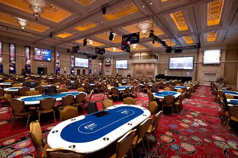 Empty Wynn Las Vegas ballroom filled with WPT®-branded poker tables before World Championship event.