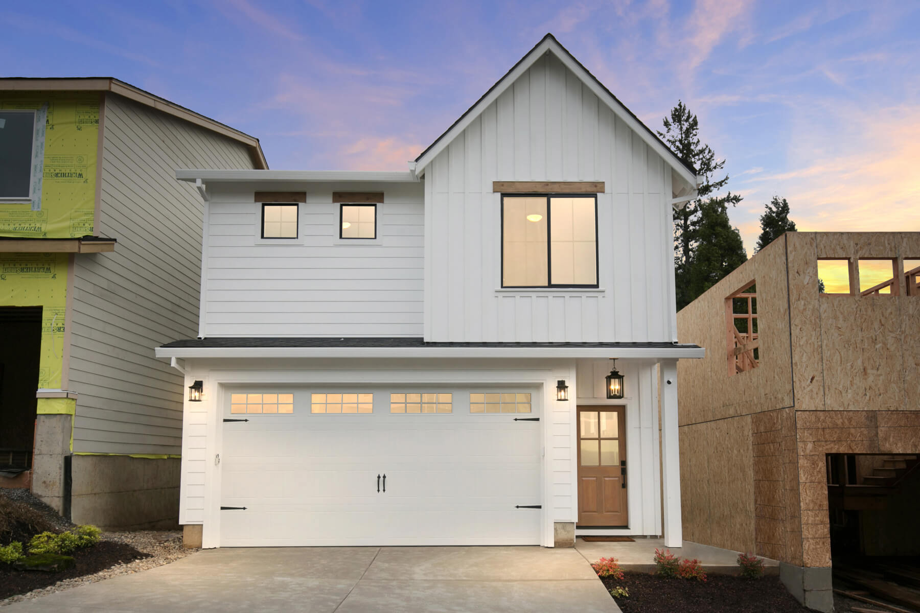 Modern residential home exterior with clean lines, large windows, and landscaped front yard.