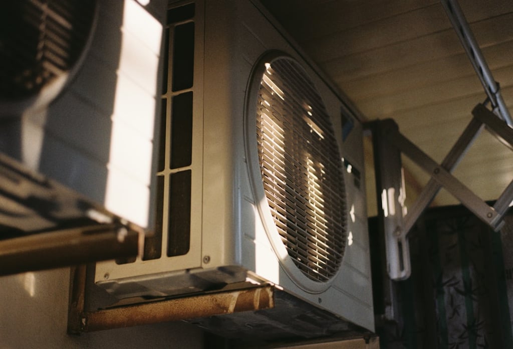 HVAC technician from Energy Savers Inc. servicing a home air conditioning unit