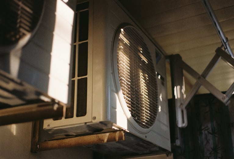 HVAC technician from Energy Savers Inc. servicing a home air conditioning unit