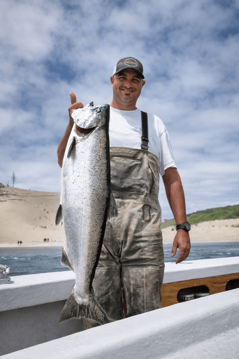 Fisherman holding a freshly caught spring Chinook salmon.