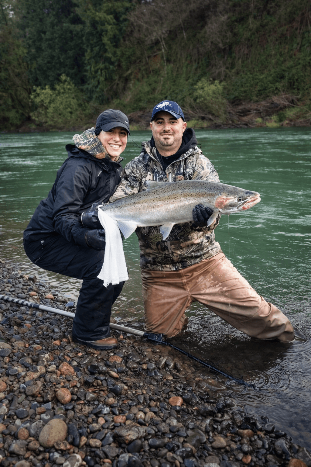 Angler holding a winter steelhead trout during a fishing trip
