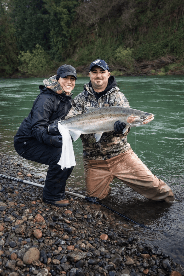 Angler holding a winter steelhead trout during a fishing trip