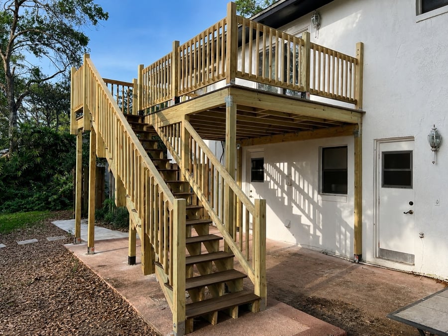 Second-story wood deck and staircase built at a Longwood home