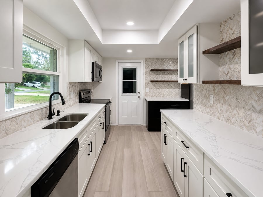 Longwood galley kitchen remodel with herringbone backsplash and quartz counters
