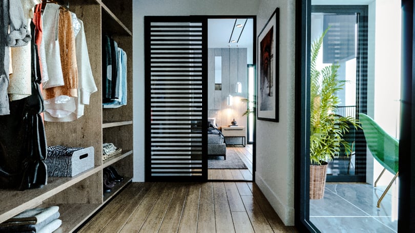 Minimalist master bedroom interior in Gebze villa with built-in wardrobe and wood flooring