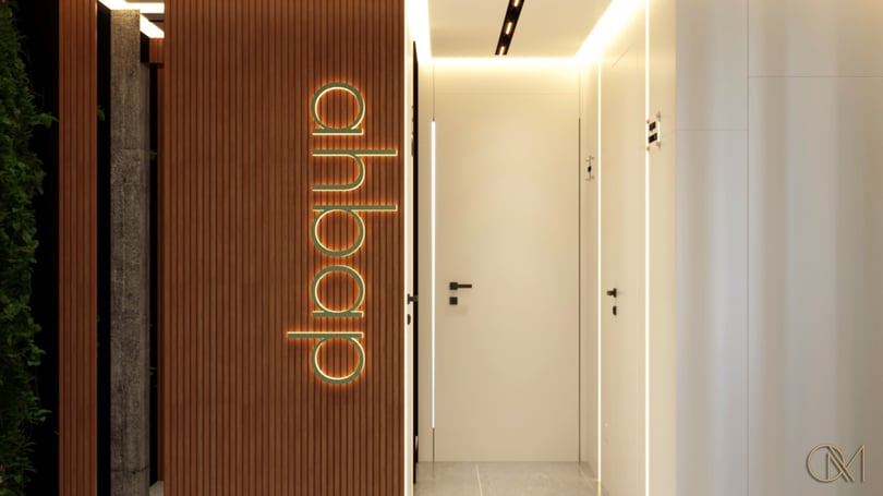 Office corridor design in Levent Istanbul with vertical wood slats, integrated LED lighting and contemporary signage