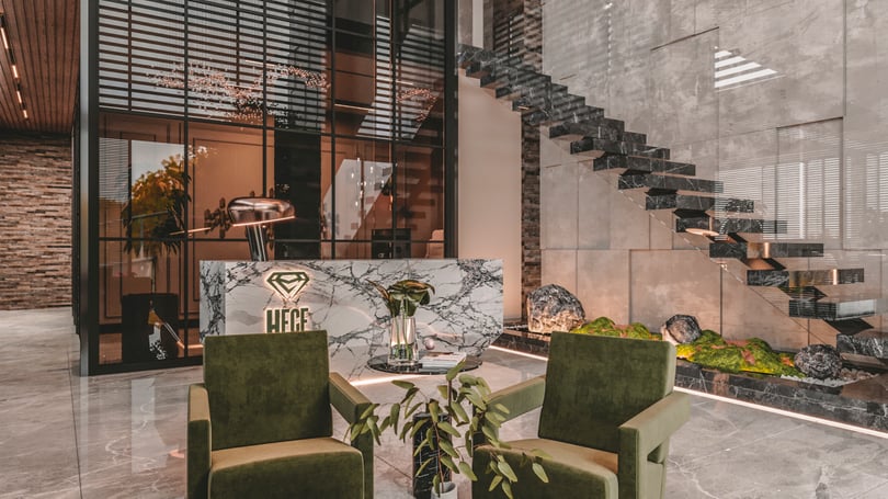 Modern reception desk detail with marble cladding and brand wall design in Yenişehir Mersin office