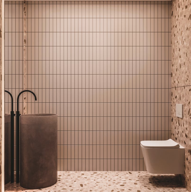 Modern guest powder room design in Amsterdam duplex apartment with terrazzo wall finish, freestanding cylindrical stone sink and matte black faucet