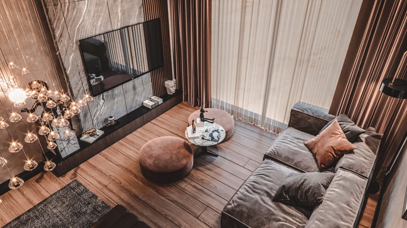 Modern luxury bedroom suite in Göktürk, Istanbul with custom ceiling chandelier, textured wall finishes, and premium wood flooring