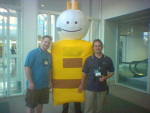 Adam standing next to the inflatable 9 guy and Jeff Sandquist