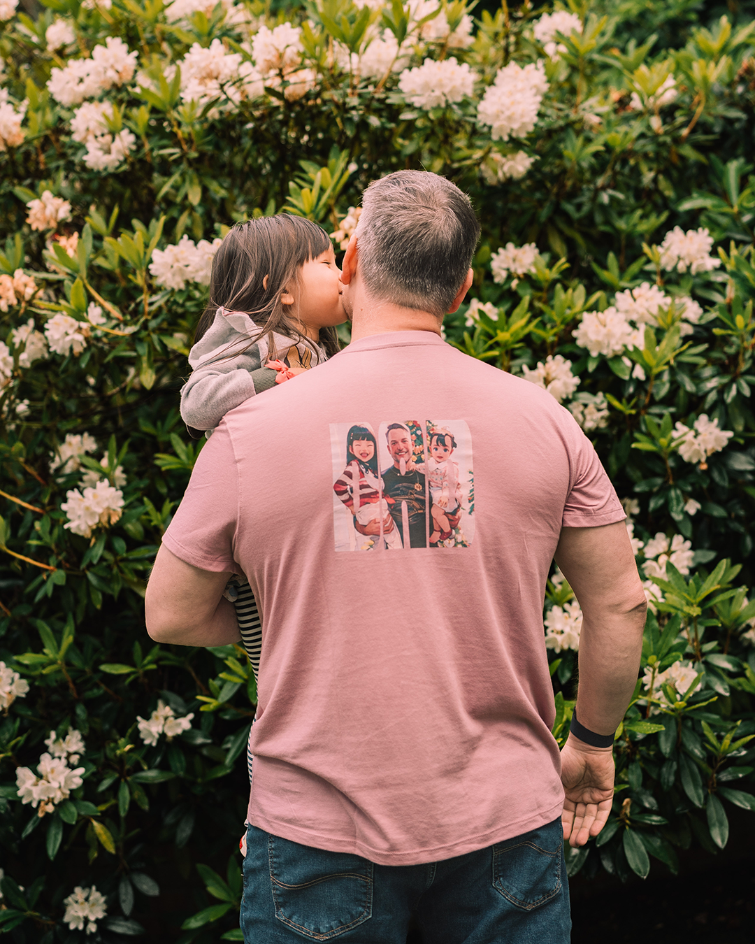 Adam wearing a new Father's day shirt while holding his daughter