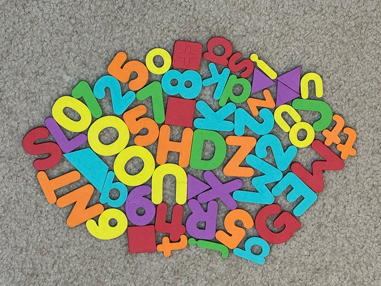 letter toys arranged on the carpet