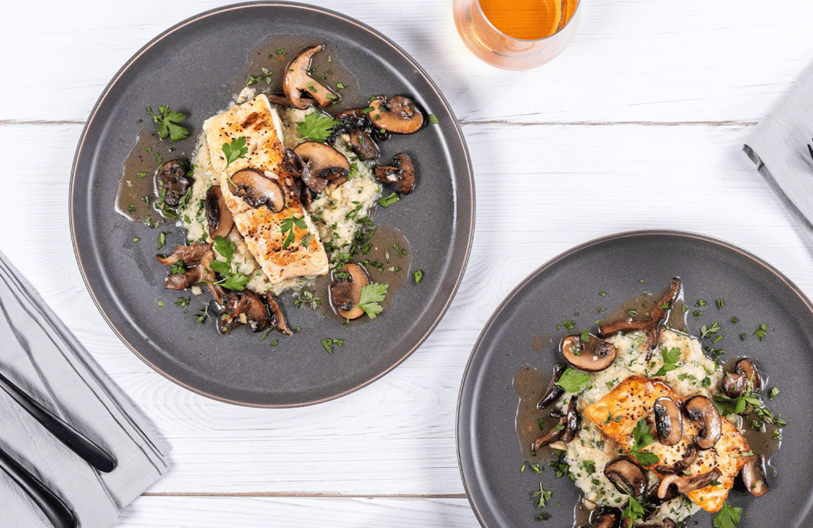 Lobster and mushrooms on a black plate