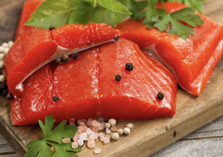 Fish cut up on a wooden cutting board