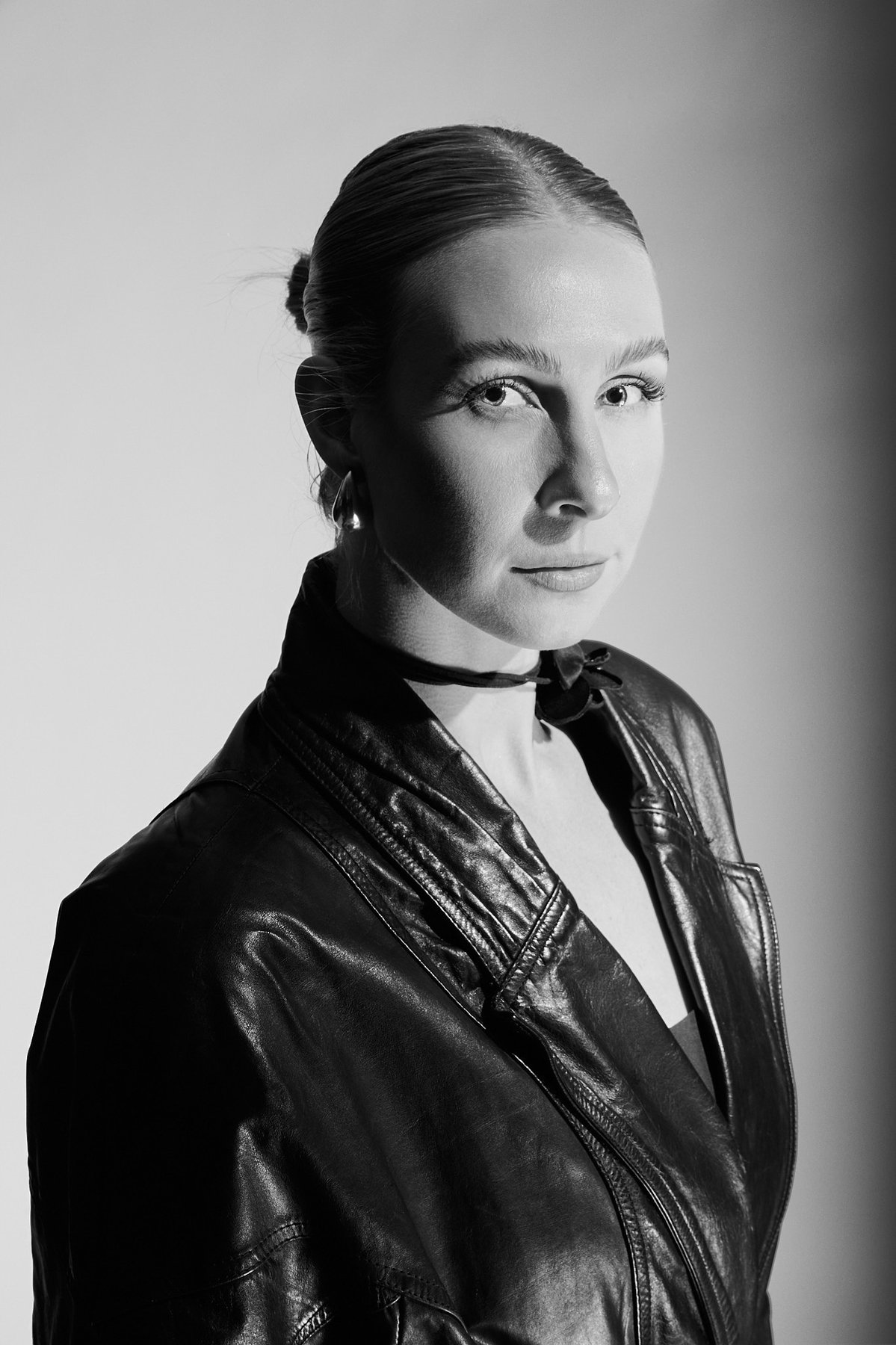 Headshot of Rachel wearing a black leather jacket.