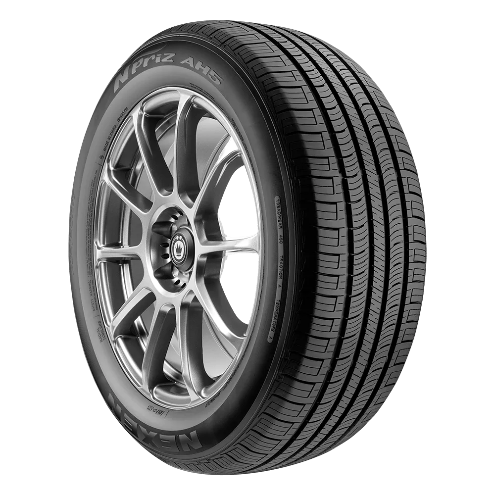 A close-up image of a Nexen N'Priz AH5 tire with an alloy wheel, showing detailed tread pattern.